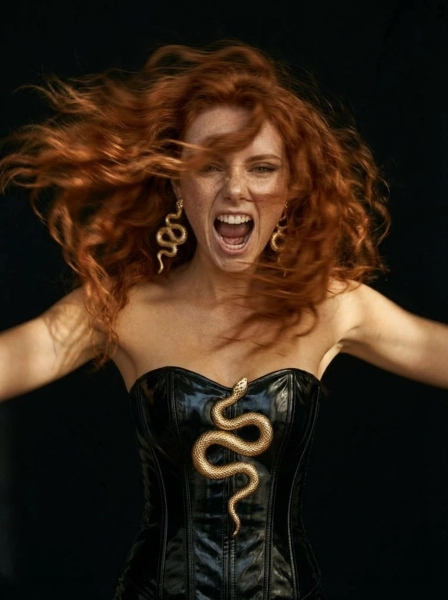 A_woman_with_long_flowing_red_hair_with_freckles_w-1774540897762