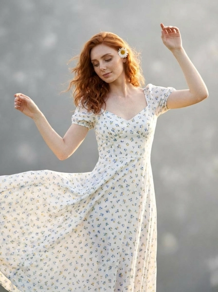 A_woman_with_wavy_red_hair_and_freckles_wearing_wh-1774496622562